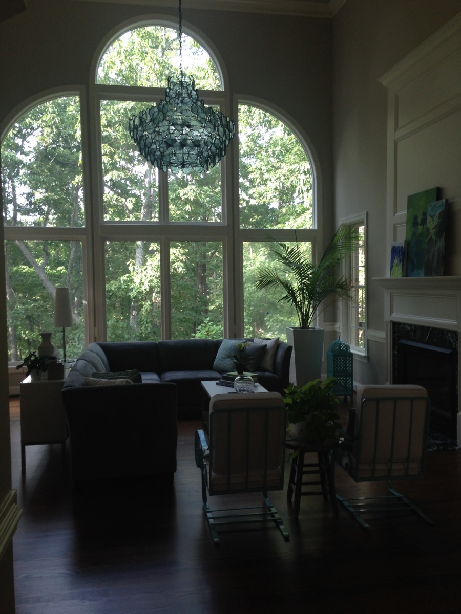 Living room with chandelier and decorative glass window